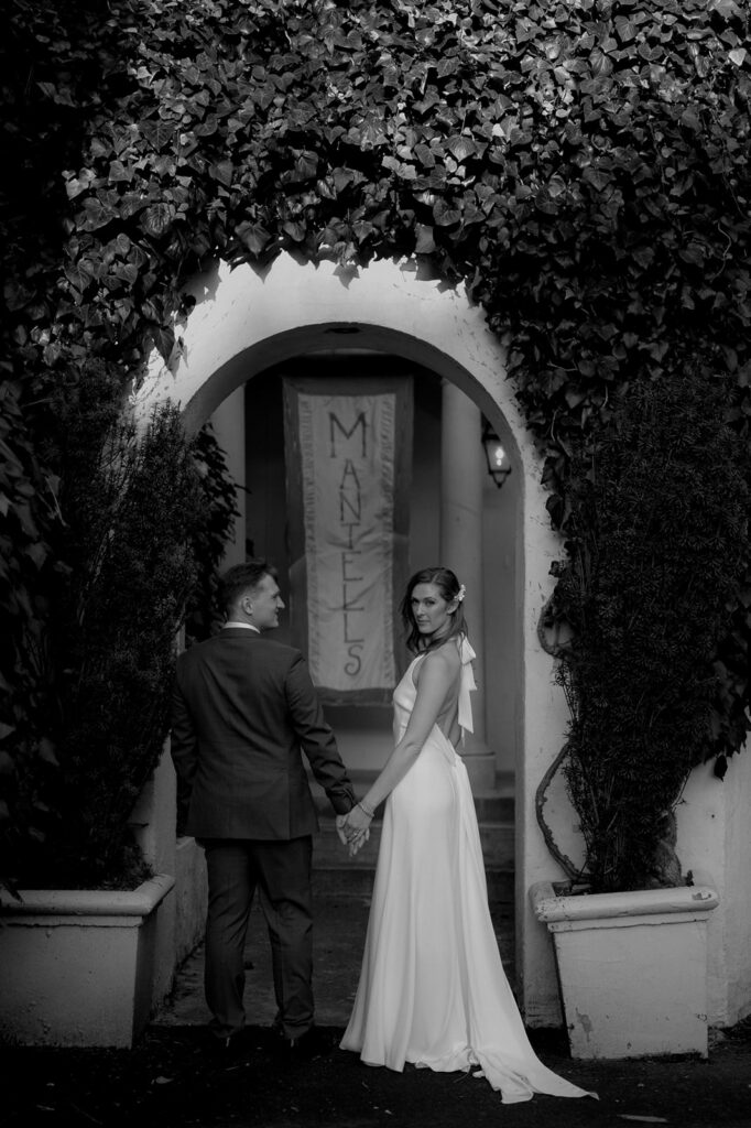 couple holding hands during wedding photos at Mantells Mt Eden