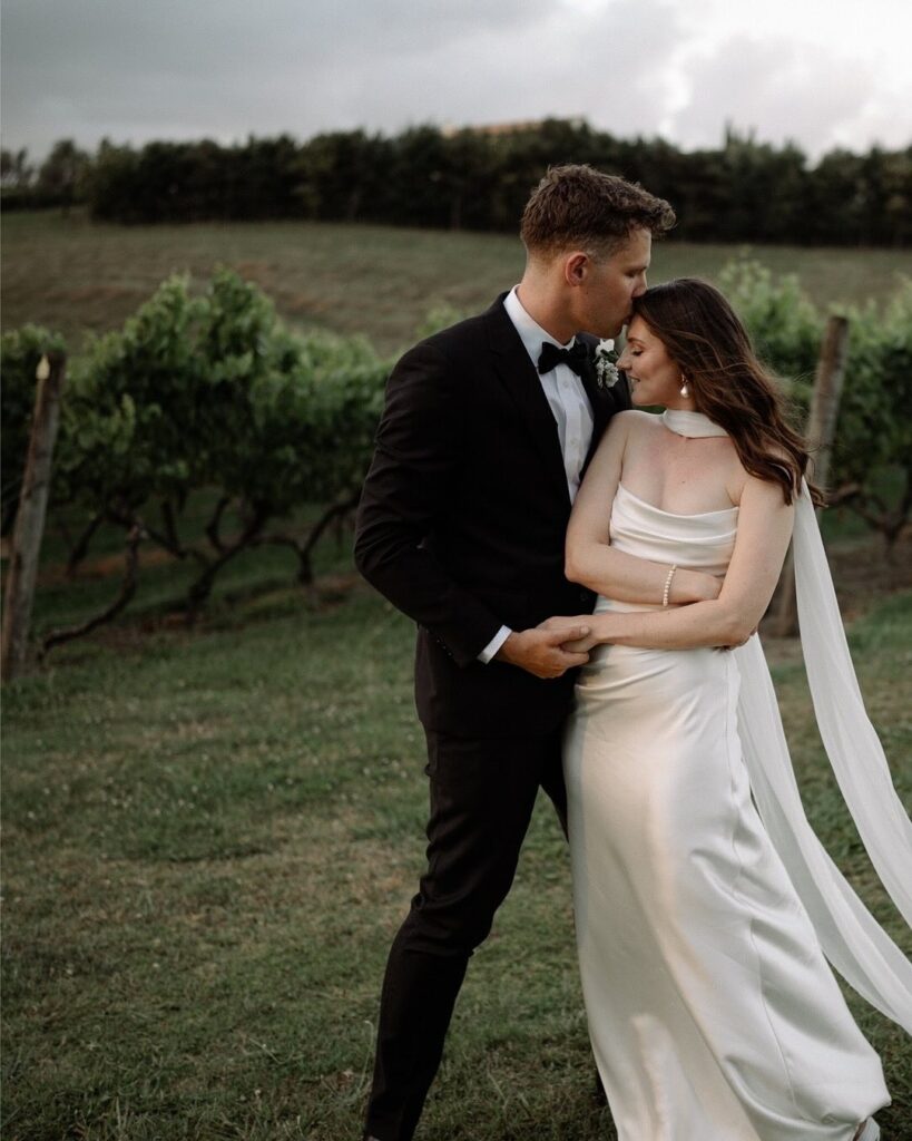 bride wearing lulu jackson bridal gown during couples portraits at Markovina Vineyard